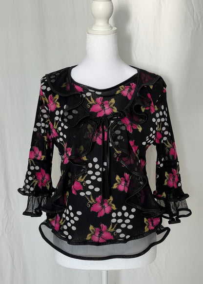 Black floral blouse on a mannequin against a white background