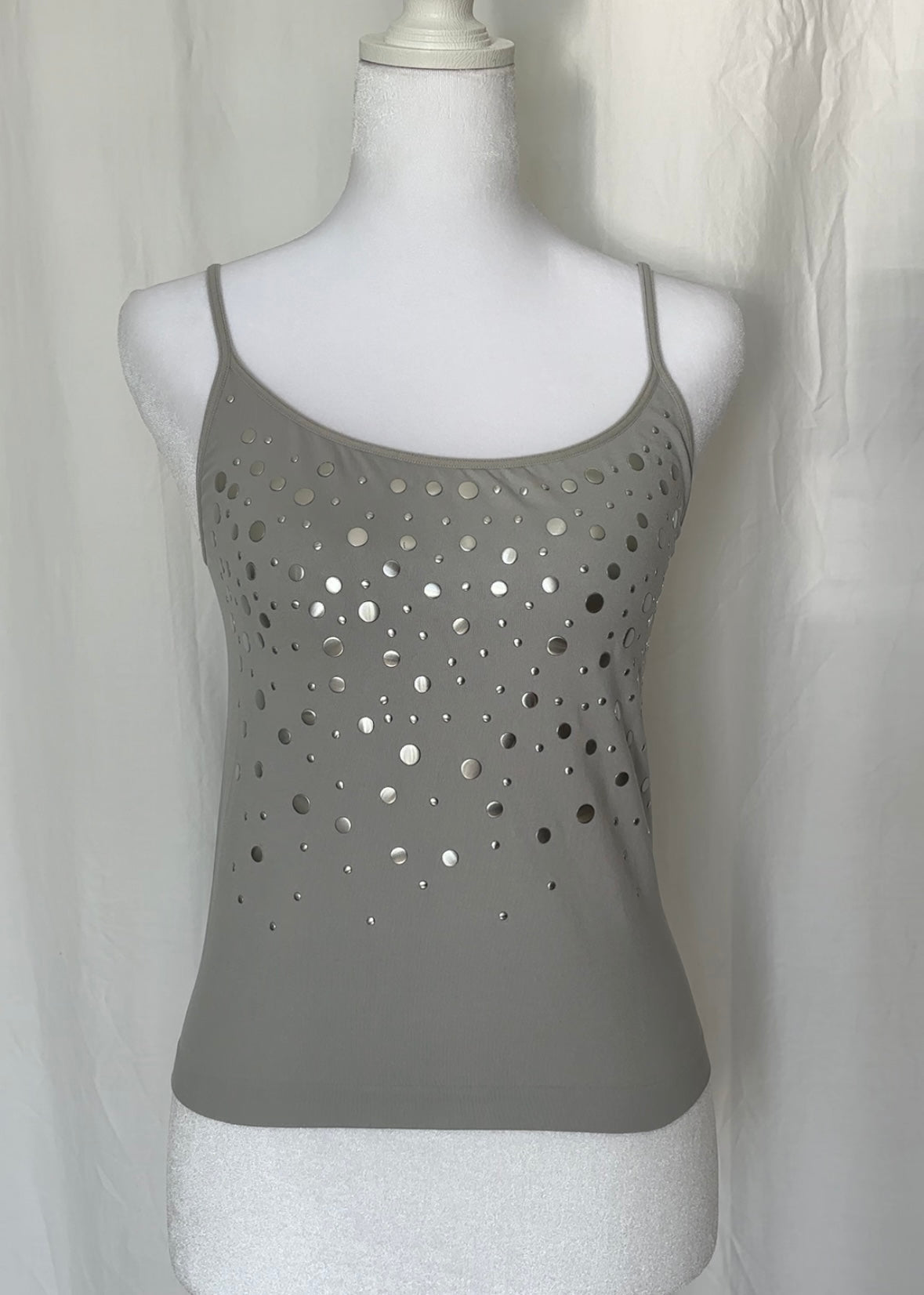 Gray tank top with cut-out design on a mannequin against a white background