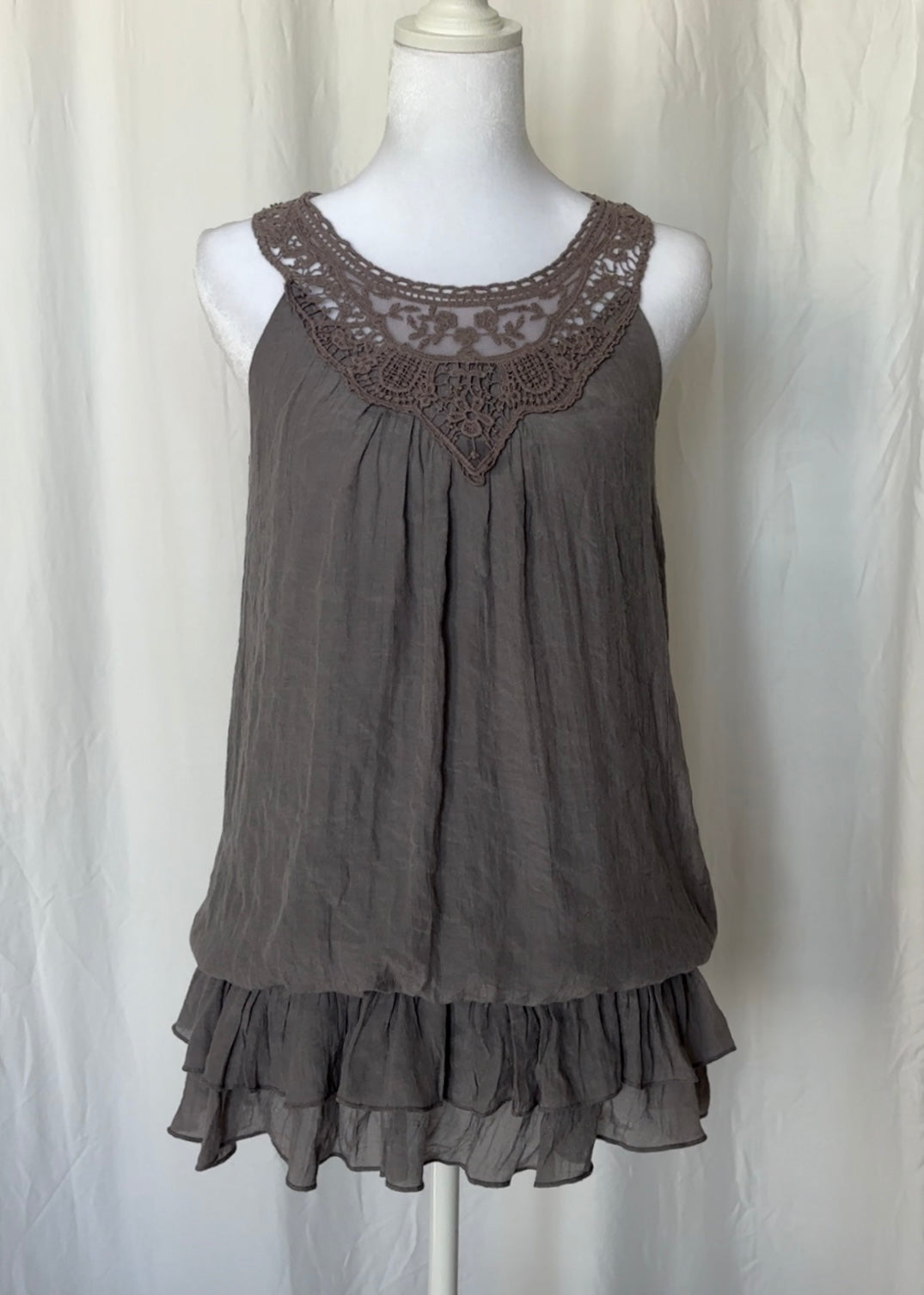 Gray sleeveless dress with lace neckline on a mannequin against a white background