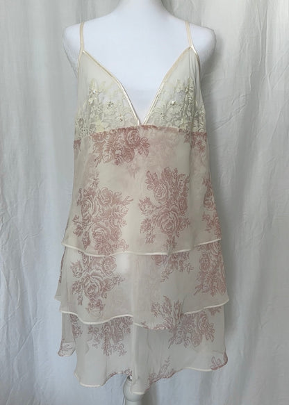 Sheer floral dress on a mannequin against a plain background