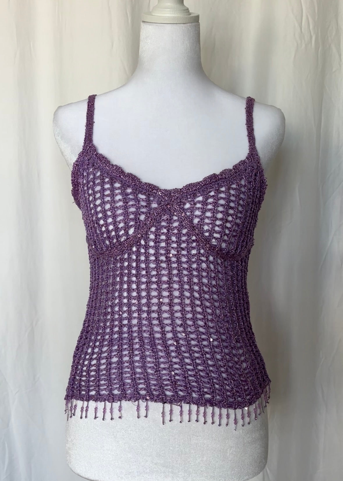 Purple crochet tank top on a mannequin against a white background